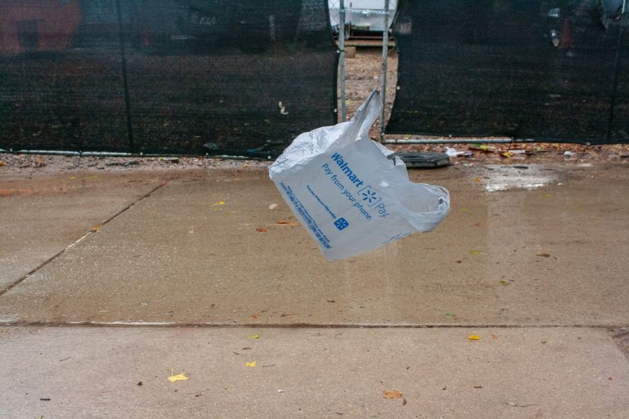 A Walmart bag flies in the wind Friday evening behind Busey-Evans Hall. Columnist Tommy challenges students to use fewer plastic bags when they shop or even when ordering food to go. 
