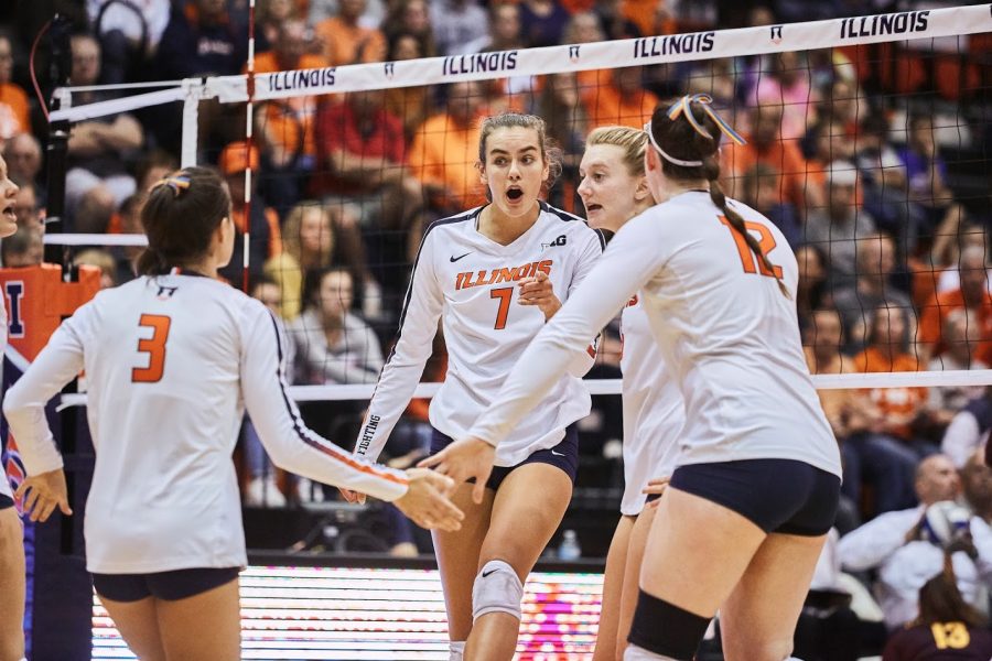 Jacqueline Quade celebrates with the Illini Volleyball team after scoring a point at Huff Hall vs Minnesota on Oct. 9. Illinois lost to Penn State on Wednesday, 3-2. 