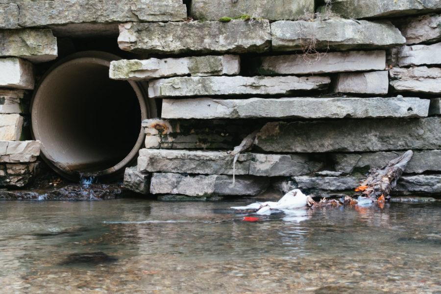 A plastic bag lies in Boneyard Creek on April 13, 2015. RSOs fundraise to reduce the effect of pollution from an old Ameren manufacturing plant near a residential area in Champaign.
