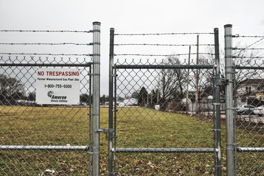 A “no trespassing” sign lies on the fence of the lot where a former Ameren gas plant was located on Sunday. The 3.5-acre plant closed in 1953, but coal tar and other waste products continue to pollute the area, causing community members to speak up and start GoFundMe fundraisers.
