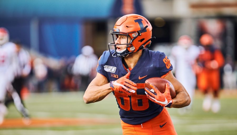 Sophomore wide receiver Donny Navarro carries the ball at Illinois’ game against Rutgers at Memorial Stadium Saturday. Navarro emerged off of Illinois’ bench as a main contributor during the Homecoming game against Wisconsin, where he caught a slant pass and broke free for a 48-yard touchdown. 