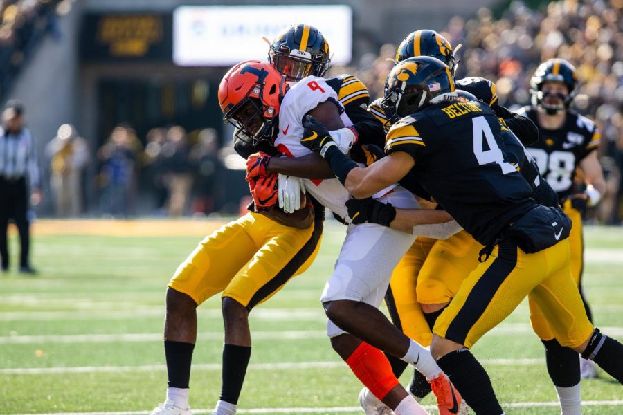Wide receiver Josh Imatorbhebhe is tackled by a swarm of Iowas defense during the Illinis game against the Hawkeyes on November 23 at Kinnick Stadium in Iowa City. Illinois lost to No. 17 Iowa, 19-10. Captured at Kinnick Stadium on 23 Nov, 2019 by Jonathan Bonaguro.