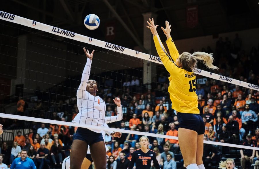 Kennedy Collins sets the ball over a Michigan defender at Huff Hall on Friday.