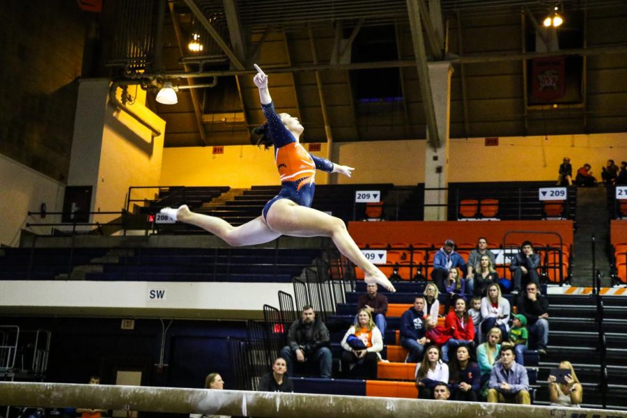 Kylie+Noonan+performs+on+the+balance+beam+at+Huff+Hall+on+Saturday.+The+Illinois+women%E2%80%99s+gymnastics+team+competed+in+the+Orange+%26+Blue+exhibition+alongside+the+men%E2%80%99s+gymnastics+team%2C+where+they+were+split+up+into+%E2%80%9Corange%E2%80%9D+and+%E2%80%9Cblue%E2%80%9D+squads+based+on+which+events+the+gymnasts+competed+in%3B+the+orange+team+won+10-9.