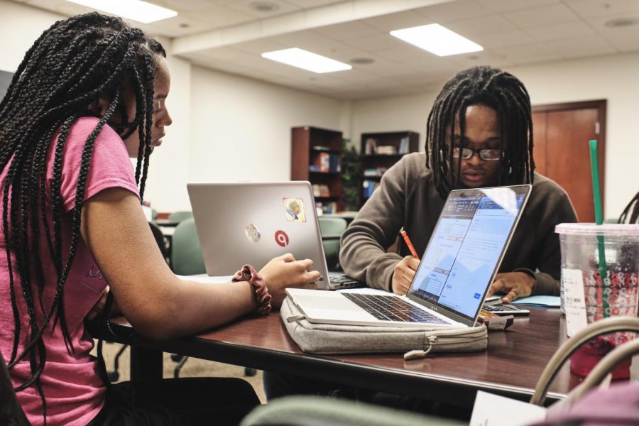Shelbi Stone, junior in Business, tutors Terik Coleman, sophomore in DGS, at the Office of Minority Student Affairs academic services center on Dec. 5. Students exercise different studying strategies for finals, like getting a tutor. 
