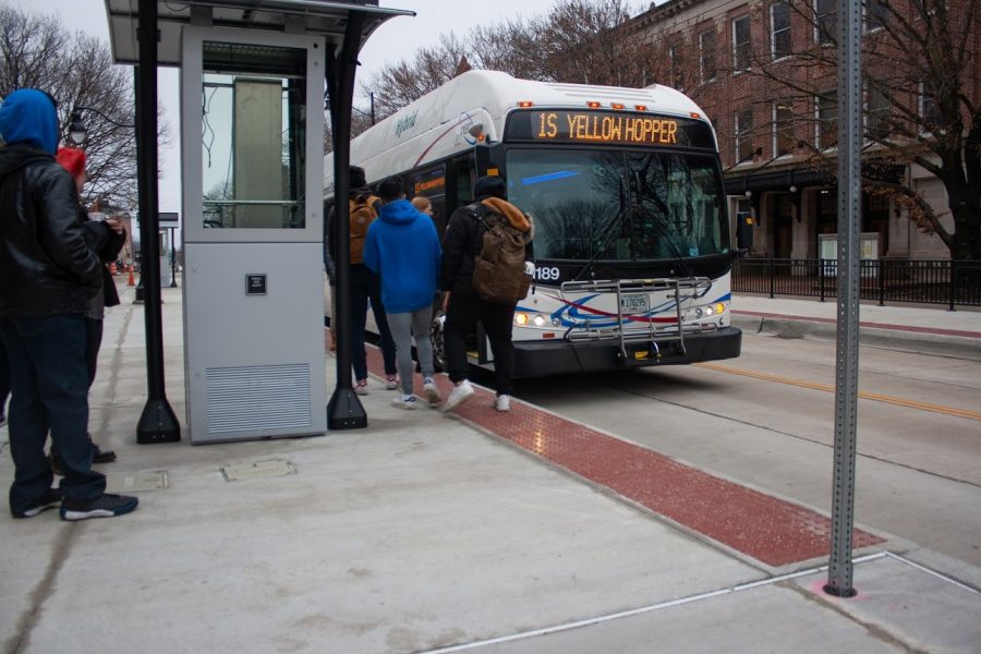 Students board the 1S Yellow Hopper bus at the newly opened southbound stop in the Transit Plaza Friday. Workers will begin to rebuild the north side of Green Street from McCullough to Race streets. 