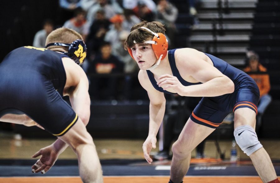 Freshman Justin Cardani wrestles against Jack Medley during the Illinois dual against Michigan at Huff Hall on Sunday.