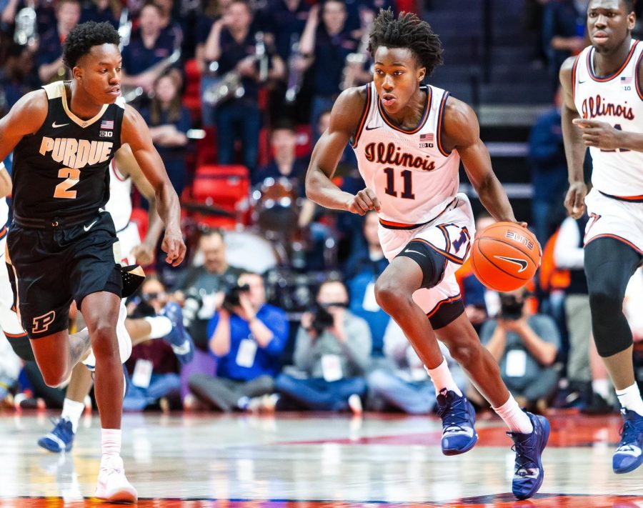 Sophomore Ayo Dosunmu dribbles past a Purdue player during the Illinis game against the Boilermakers at the State Farm Center Jan. 5. Photo by Jonathan Bonaguro. 