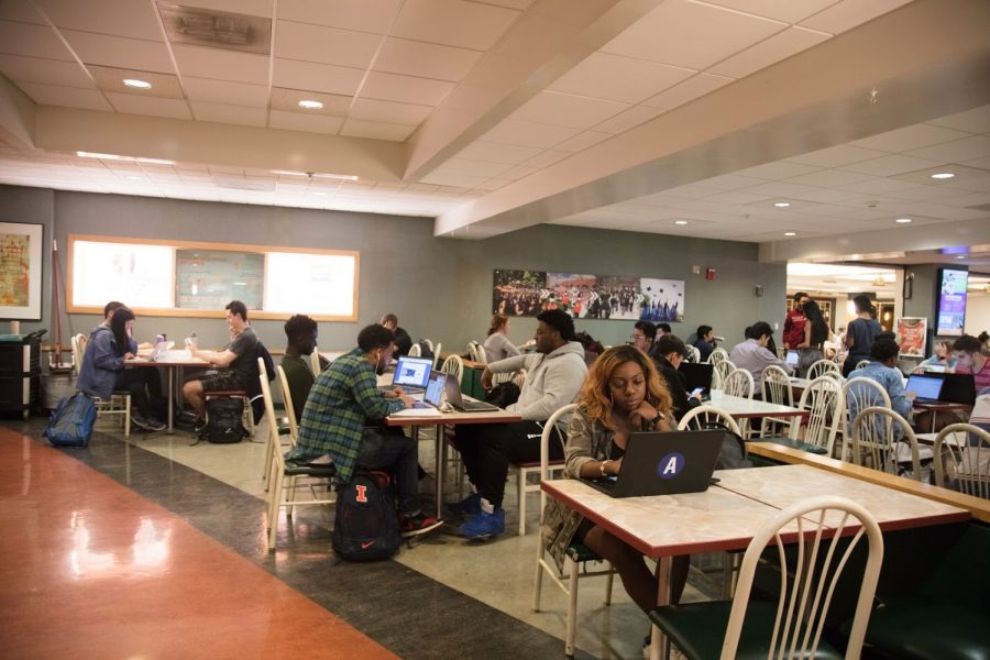 Students at the basement of Illini Union on April 16 eating lunch and working on their laptops. 