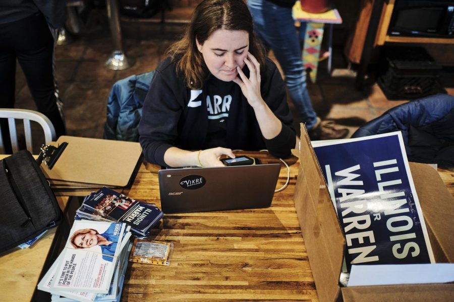 Tori Hill, an organizer for the Warren Campaign, prepares canvassing materials at Caffe Paradiso on Sunday afternoon.