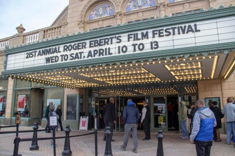 People gather for the Ebert Film Festival at the entrance to Virginia Theatre on April 10. 