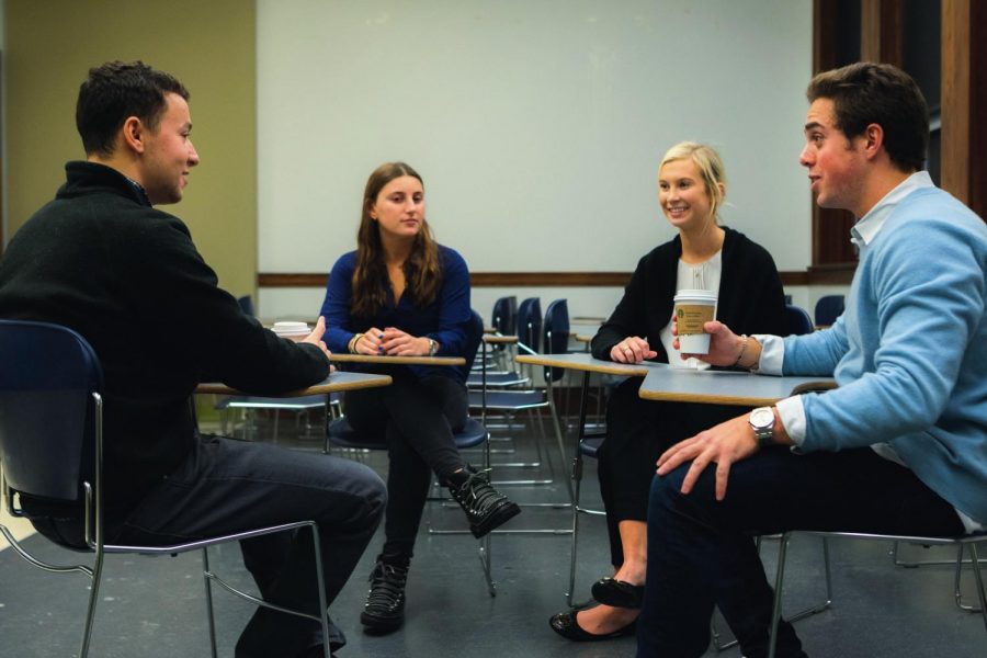 Dylan Abrams (left), Blair Polinsky (center-left), Katie Underwood (center-right) and Jake Tennant, founders of College Ventures, discuss the organization’s future plans on Tuesday evening. College Ventures was initially started to make education more accessible for those with limited financial means in the Champaign-Urbana area, with the ultimate goal of funding Champaign Central High School students’ University tuition. 