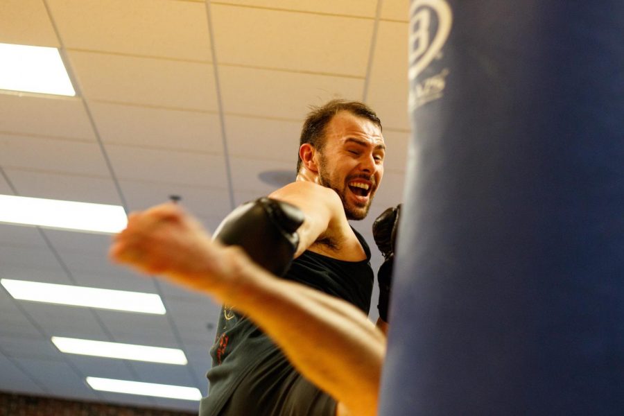 Adam Taggart, second year doctoral student in kinesiology, practices his kickboxing skills. This hobby turned into a field of research for Taggart, as he is studying the effects of martial arts on cognitive functions.