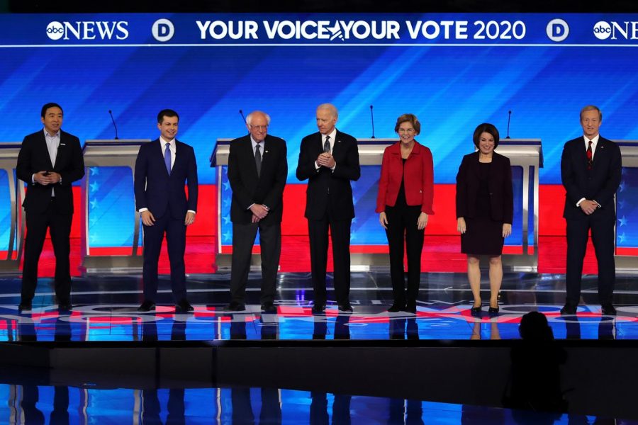Democratic presidential candidates stand on stage before the Democratic Presidential Primary Debate in the Sullivan Arena at St. Anselm College in Manchester, N. H., on Feb. 7. Columnist Dylan believes debates unnecessarily dramatize the overall election system.