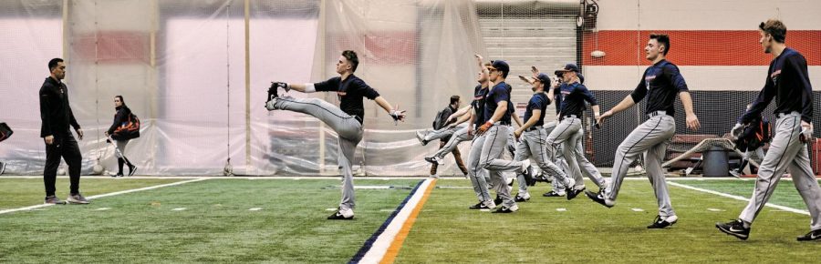 The Illini baseball team stretches during their practice at the Irwin Football Facility on Wednesday. The first Illinois baseball game is on Friday, Feb. 14 against Milwaukee in Winston-Salem, North 