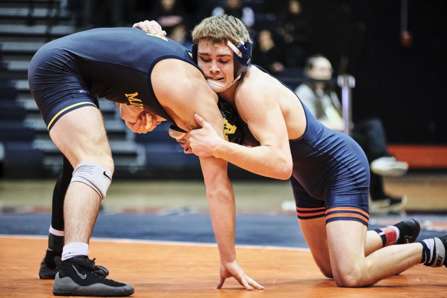 Senior Travis Piotrowski takes down Michigan opponent Garrett Pepple during Illinois’ dual meet against Michigan at Huff Hall on Jan. 26. The Illini are 7-3 overall and 4-2 in Big Ten conference play.