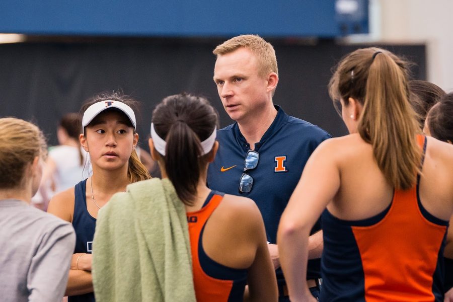 Illinois head coach Evan Clark talks to his team during the match against Rutgers at Atkins Tennis Center on Friday, March 29, 2019. The Illini won 6-1.