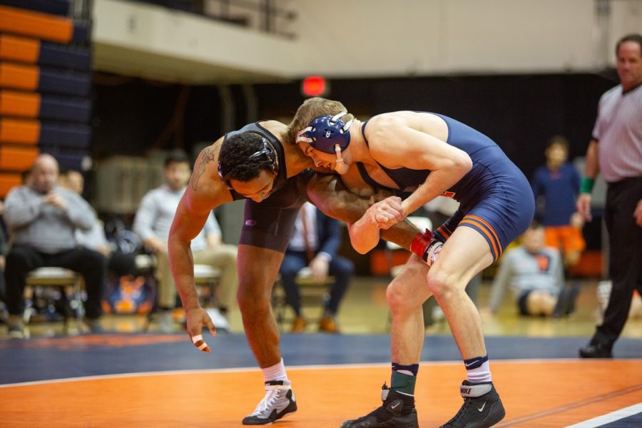 Senior Travis Piotrowski wrestles a Purdue opponent during the Illinois dual against Purdue at Huff Hall on Feb. 16.