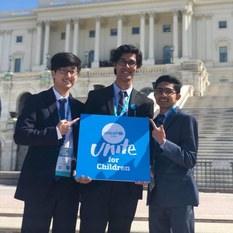 Philip Song (left) poses with Avishek Biswas (center) and  Utsav Vachhani with a UNICEF sign in front of the White House in Washington D.C. on March 21, 2019.