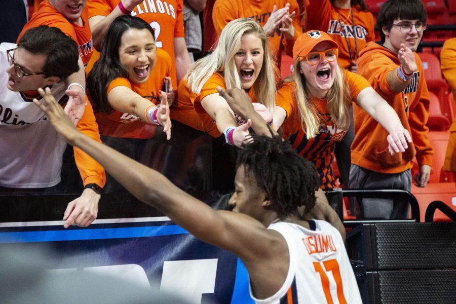 Sophomore guard Ayo Dosumnu reaches his hands out to the student section.