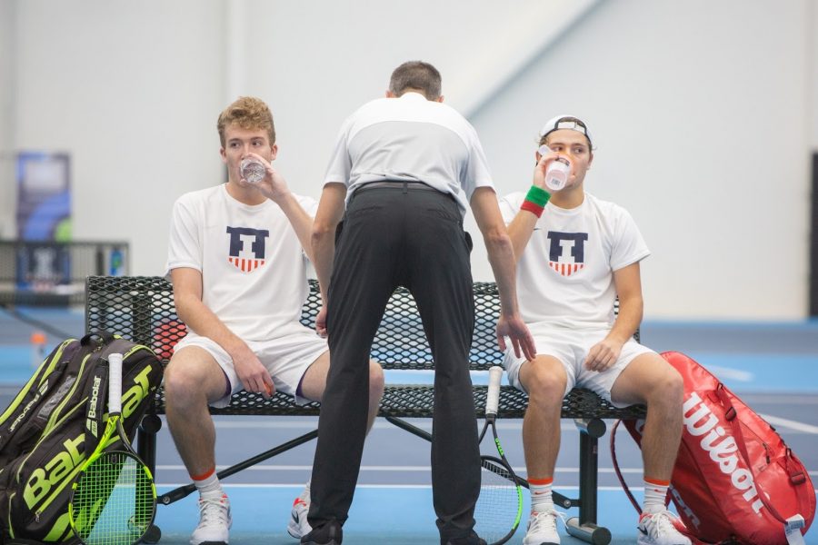 Junior Alex Brown and senior Aleks Kovacevic rest between sets as head coach Brad Dancer encourages them during a doubles match against Baylor Feb. 29. After their season was abruptly cancelled, the players are focusing on directing their disappointment to empower their futures.