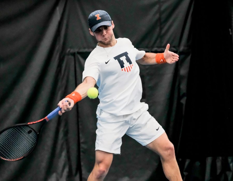 Zeke Clark returns the ball during the meet against Chicago State at Atkins Tennis Centeron Feb. 15.
