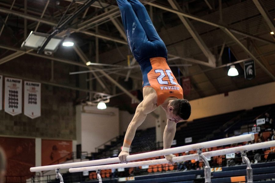 Senior Sebastian Quiana performs on the parallel bars during the Illinois meet against Penn State at Huff Hall on March 7.