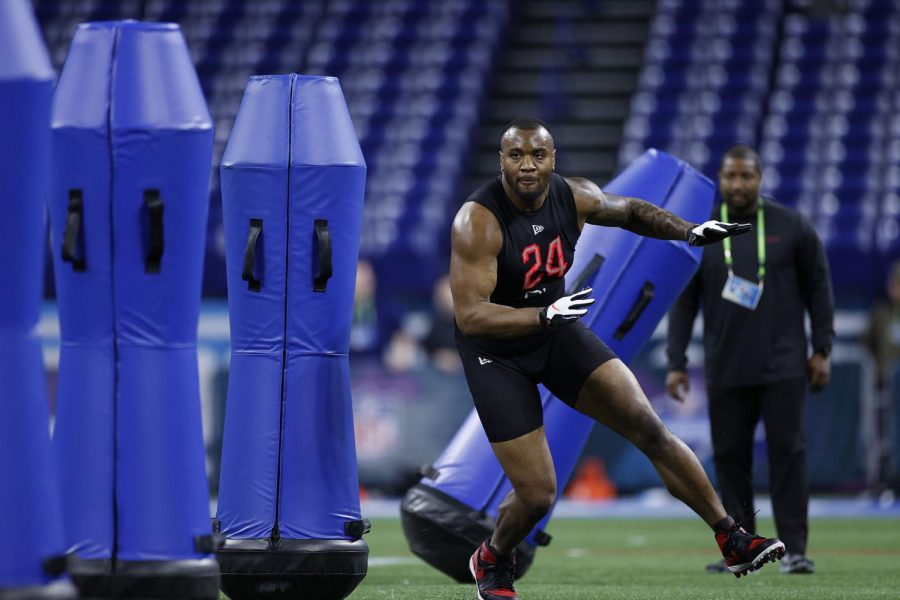 Defensive lineman Raekwon Davis of Alabama runs a drill during the NFL Combine at Lucas Oil Stadium in Indianapolis on Feb. 29, 2020. 
