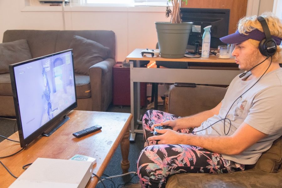 Mike Hoke plays a game of Fortnite in his apartment on Oct. 13, 2018. Students stuck at home during quarantine can ease their boredom with video games like Fortnite activities.