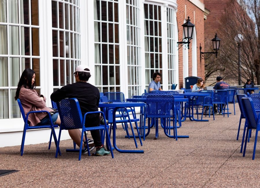 Illinois students study and lounge on the tables outside of the Illini Union on Friday.