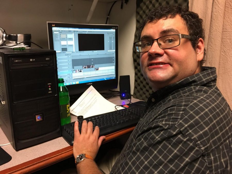 Urbana Public Television Producer Andrew Scolari edits video at his workstation.