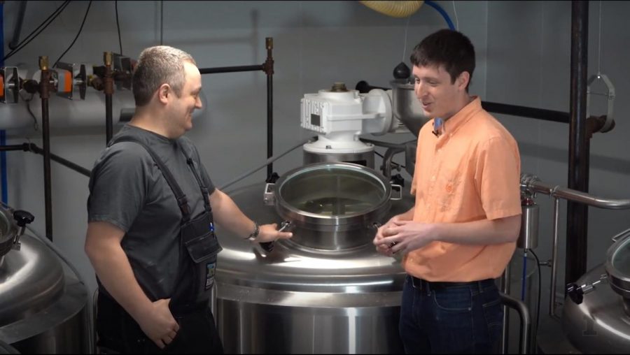 FSHN 175 Teaching Assitsant Max Holle (right) takes an on-site tour of Riggs Beer Company with Darin Riggs (left) for a video for his class.
