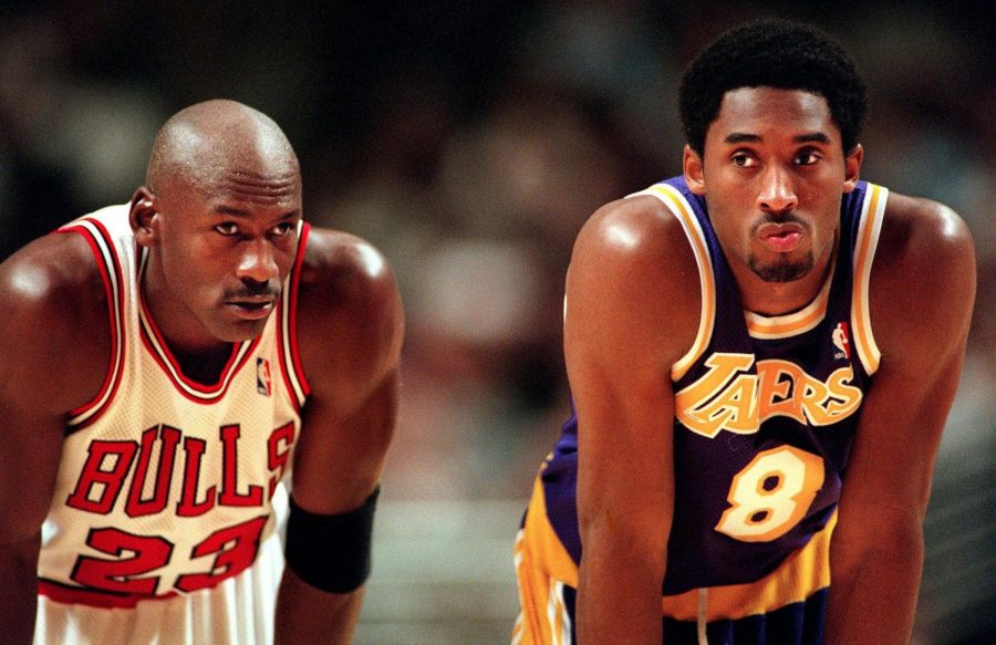 Michael Jordan and Kobe Bryant look on during free throws during a game at the United Center on Dec. 19, 1997.