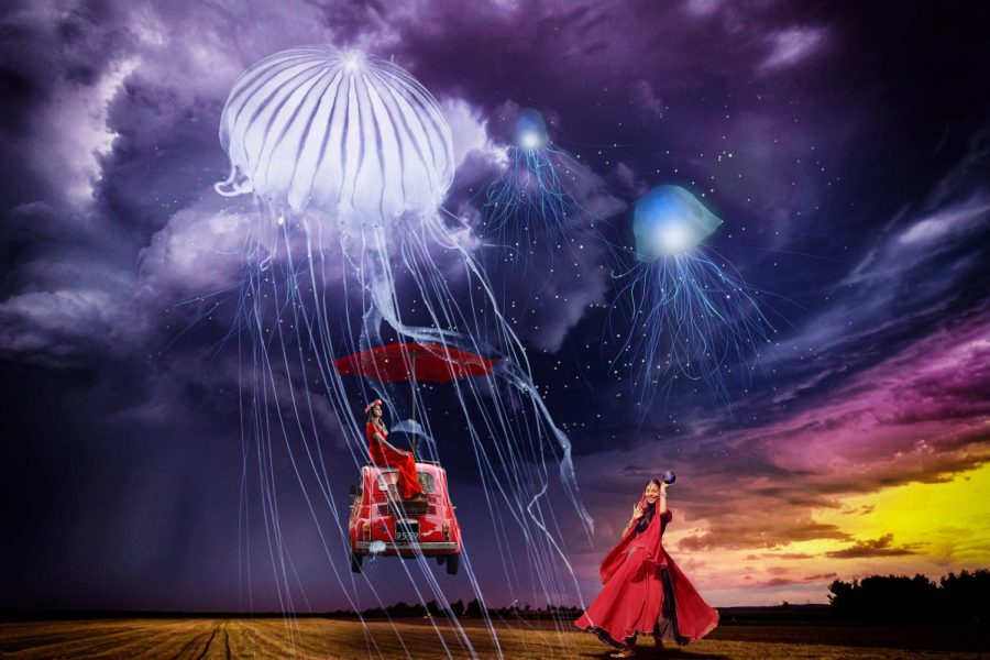 Two women are seen in a field surrounded by dark skies and flying jellyfish.