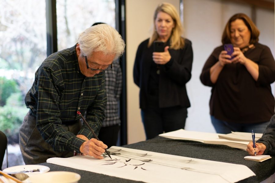 University Art and Design Professor Shazo Sato explains how to paint  bamboo with black ink. Here he teaches his Black Ink Painting class at the Japan House on Nov. 17, 2019.