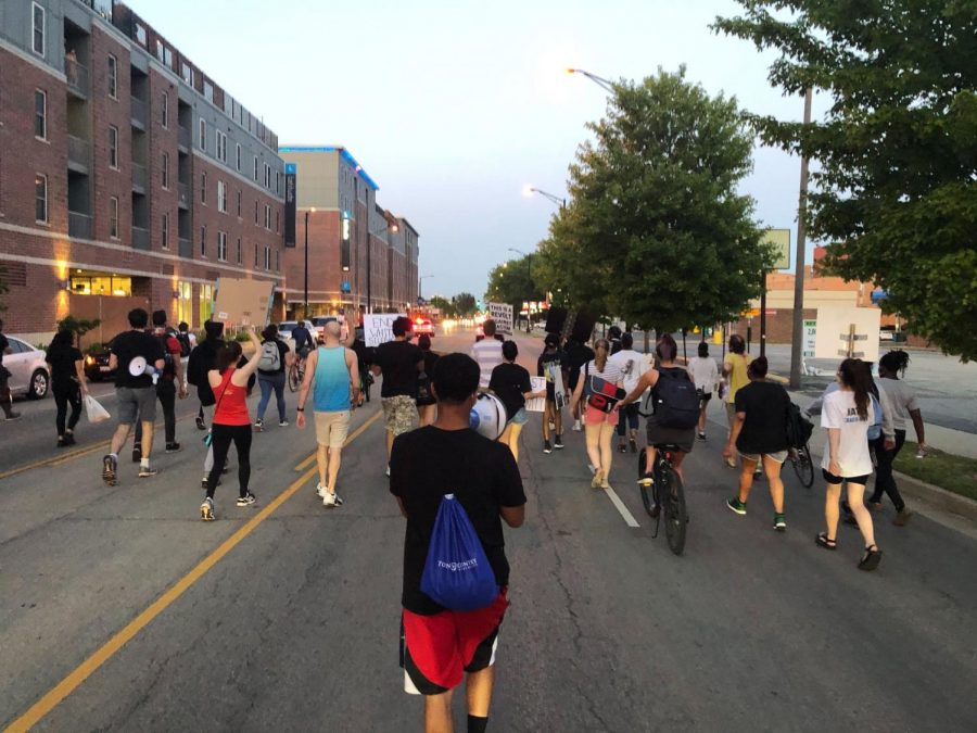 Demonstrators march down Unviersity Avenue in Champaign, IL on June 16 during a protest sparked by the reinstatement of the Urbana Police Chief Bryant Seraphin.