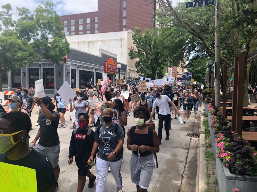 Demonstrators march south on Neil Street during a protest in Champaign, IL on Sunday.