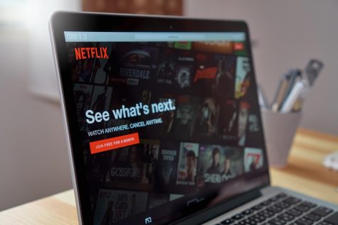 The Netflix homepage displays itself on a laptop screen 