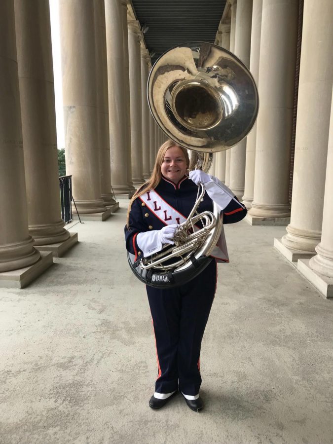 Jensen stands with her instrument in her Marching Illini uniform.