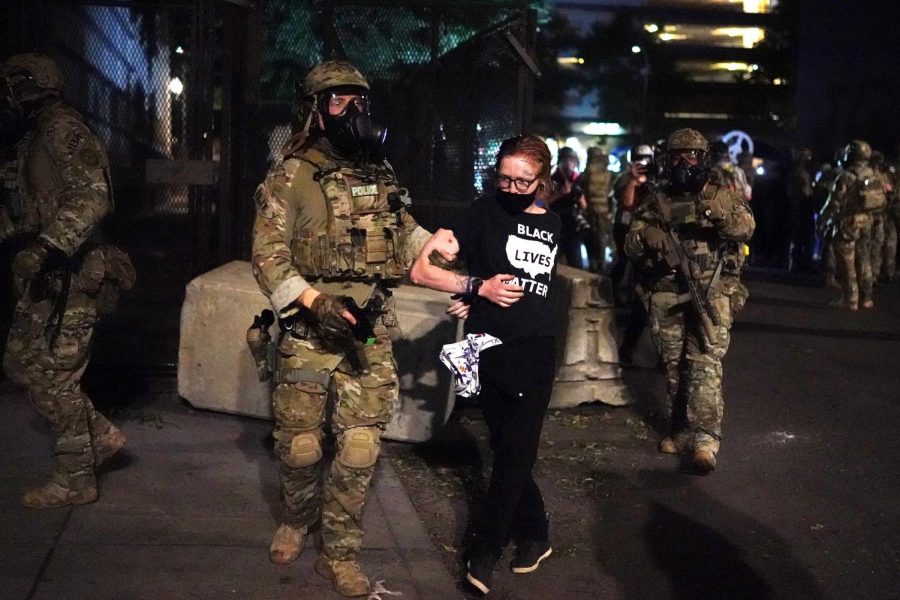 Federal officers arrest a protester after dispersing a crowd of a few hundred people from in front of the Mark O. Hatfield U.S. Courthouse in the early hours of Thursday, July 30, 2020, in Portland, Oregon.