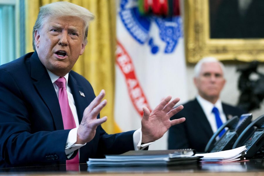 U.S. President Donald Trump talks to reporters with Vice President Mike Pence in the Oval Office at the White House July 20, 2020 in Washington, DC.