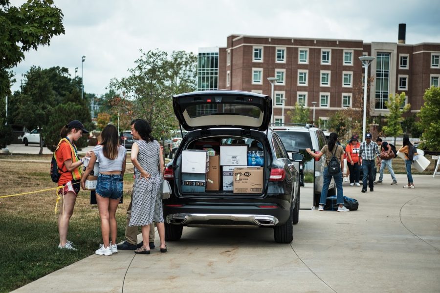 I-Guides assist multiple families near their cars as they move their children into the dorms on Aug. 22, 2019.