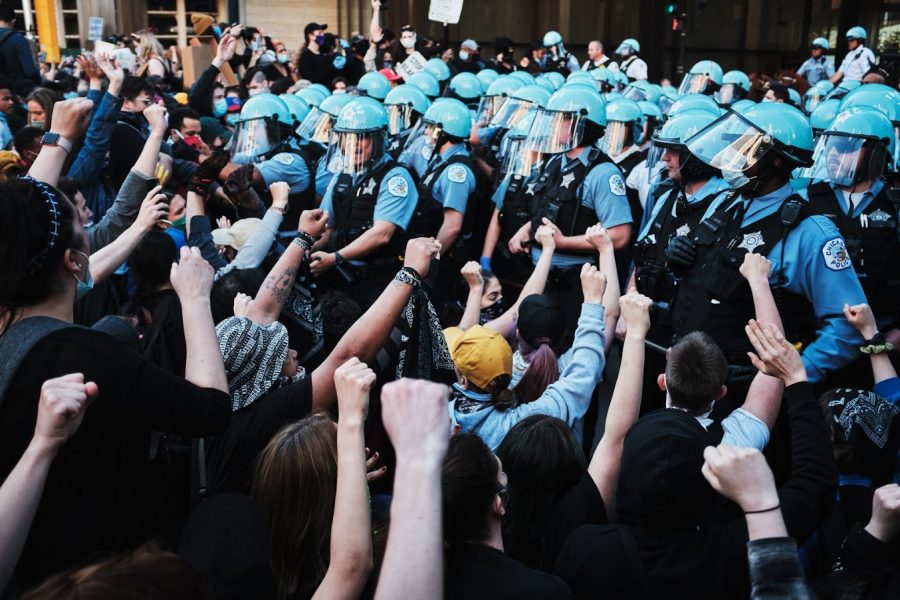 Chicago police officers form a line in front of demonstrators during a protest on May 30. Columnist Maii argues the CPD is responsible for much of the violence occurring on Aug. 15.
