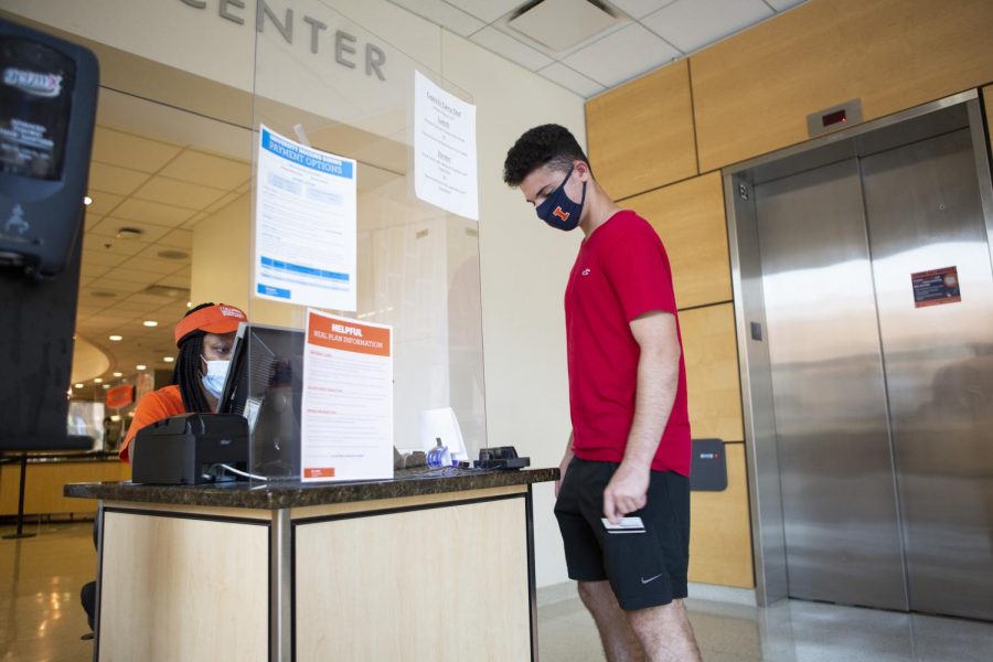 A student swipes his i-card to enter the Ikenberry Dining Hall on Sunday. On-campus dining facilities created new adjustments in the wake of COVID-19.
