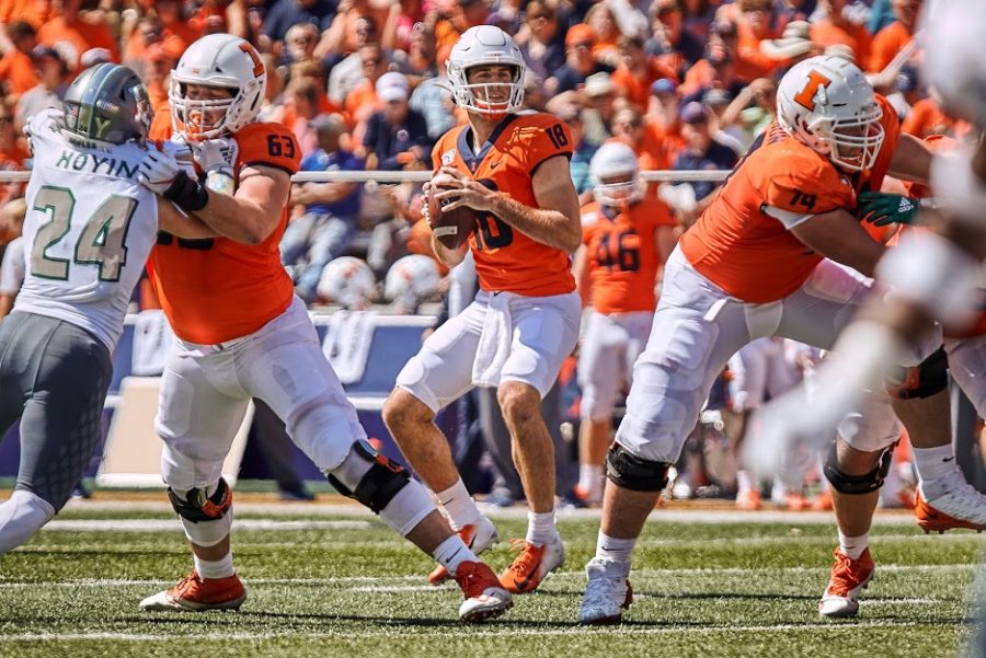 Senior+Quarterback+Brandon+Peters+scans+the+field+as+the+offensive+line+protects+him+during+the+match+against+Akron+on+Sep.+14%2C+2019.Peters+will+be+returning+to+Illinois+for+one+more+season.