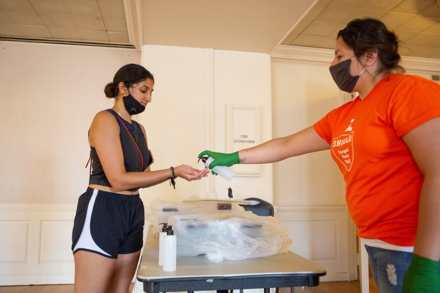 Aisha Shekara takes a COVID-19 test at the Illini Union on Sunday. New COVID-19 rules and restrictions have been applied to the Champaign-Urbana and Campustown areas this week.