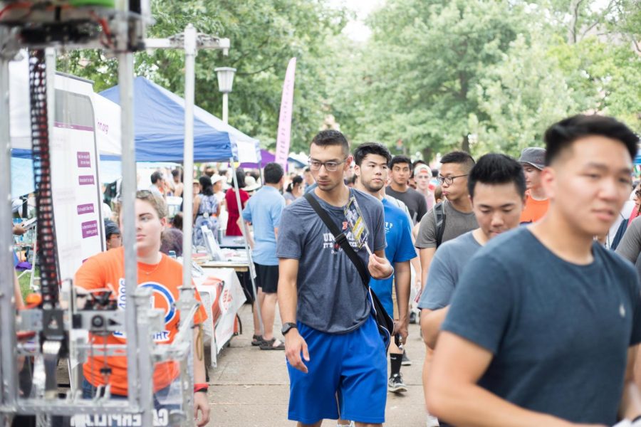 A student looks at an RSO’s table as he passes by during Quad Day on Aug. 26, 2018.
