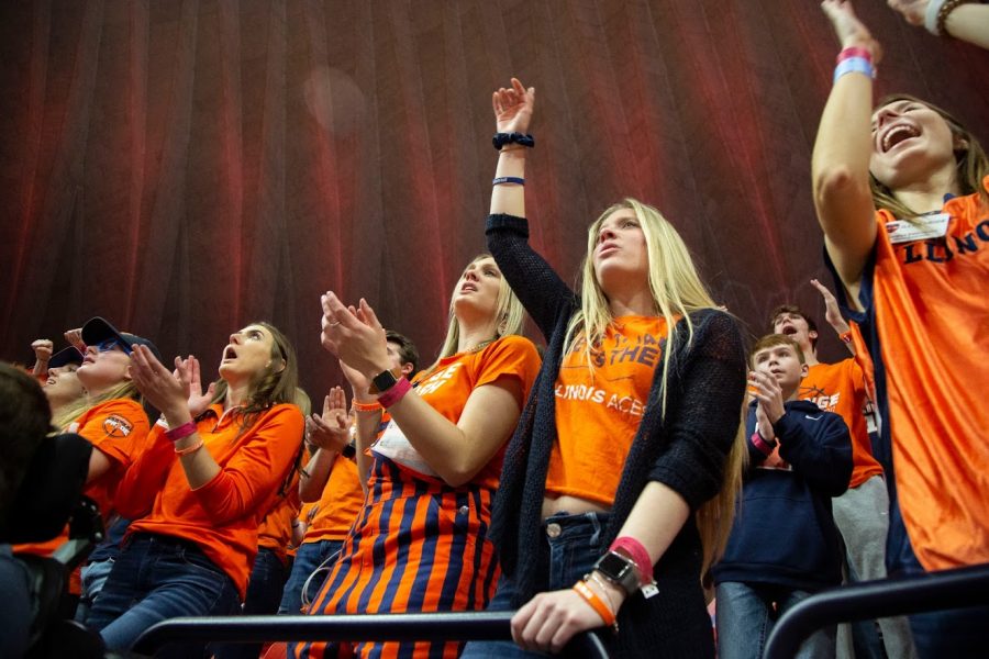 Students in the Orange Krush fan section cheer for the Illini basketball team during their match against Iowa on March 8 at State Farm Center. The Illini social media team is using social media to engage with fans.