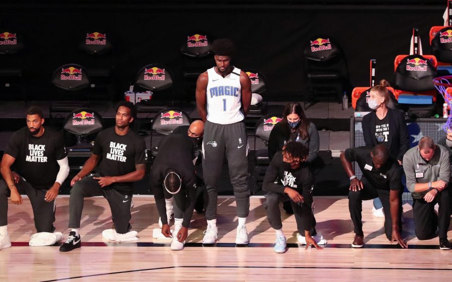 A majority of the Orlando Magic players kneel while wearing Black Lives Matter t-shirts before a game against the Brooklyn Nets at Disneys Wide World of Sports HP Field House on Friday, July 30th.