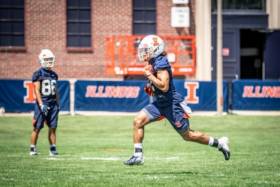 Illinois+running+back+Chase+Brown+runs+the+football+at+training+camp+on+Aug.+6.+The+Illini+had+their+season+postponed+just+five+days+later.+